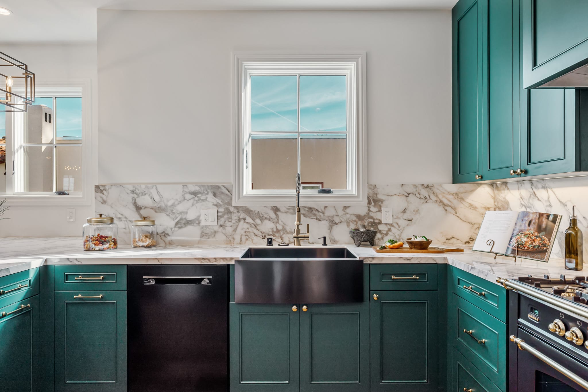 Teal kitchen cabinets with black farmhouse sink, black range, and marble backsplash at 115 Humboldt Road, Burlingame