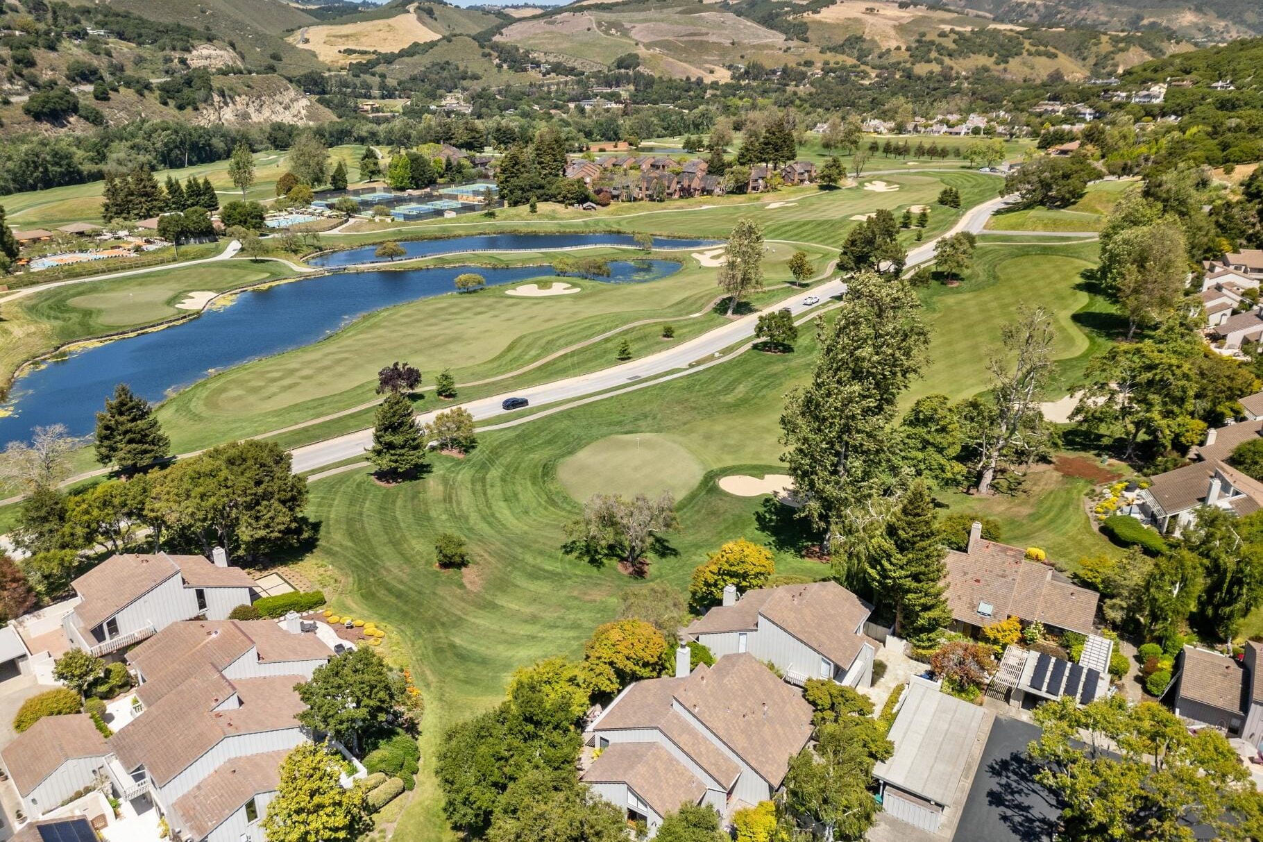 erial view of Carmel Valley Ranch golf course with pond, fairways, and surrounding homes in Carmel, CA.