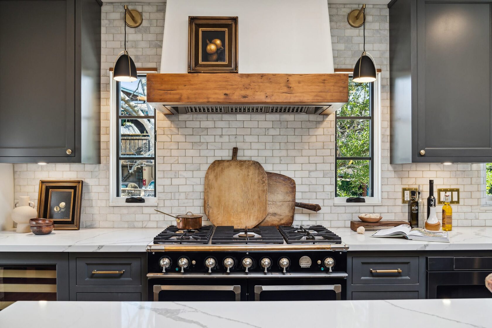 Black La Cornue range with custom wood range hood, white/cream subway tile backsplash, and dark charcoal cabinets at 137 Oak Knoll Avenue, San Anselmo