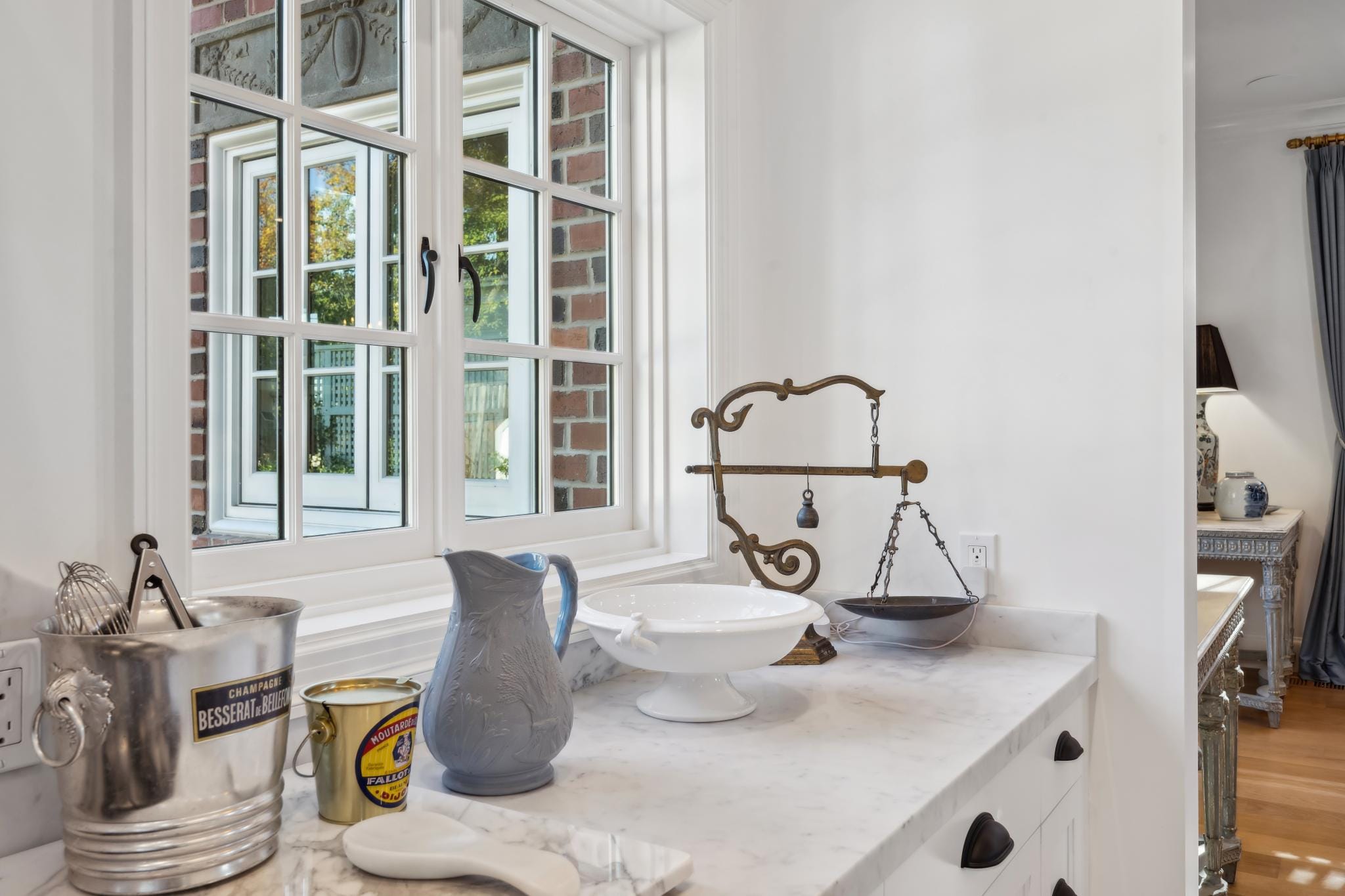 White kitchen counter detail with black cup-pull hardware, marble countertop, and kitchen accessories at 853 D Street, Petaluma
