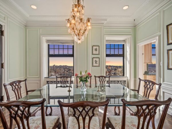 Twilight shot of the dining room of 1201 California Street Unit 1602 in the Cathedral Apartments