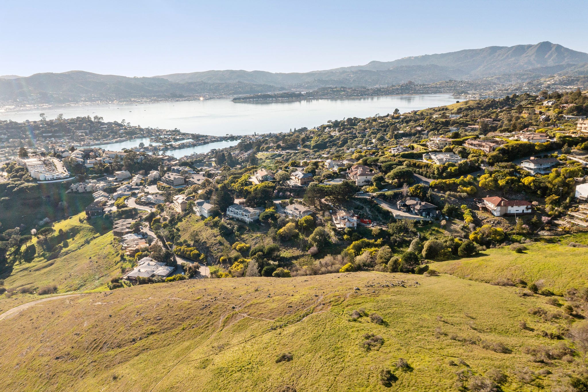 Aerial view of Belvedere hillside homes above Richardson Bay with Marin County hills in the background
