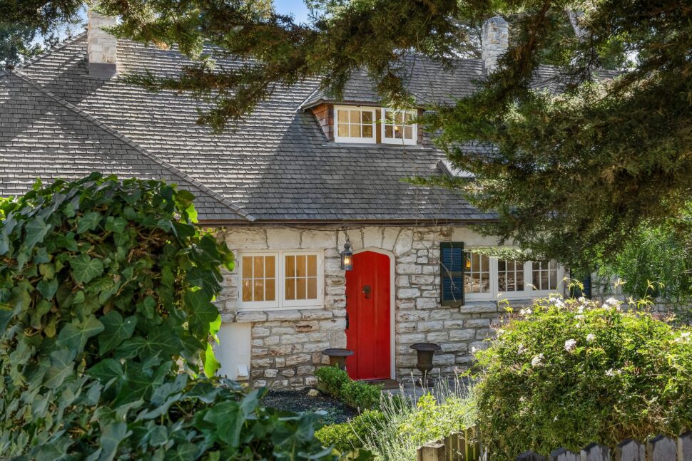 The front of a Carmel-by-the-Sea home peeks through shrubbery