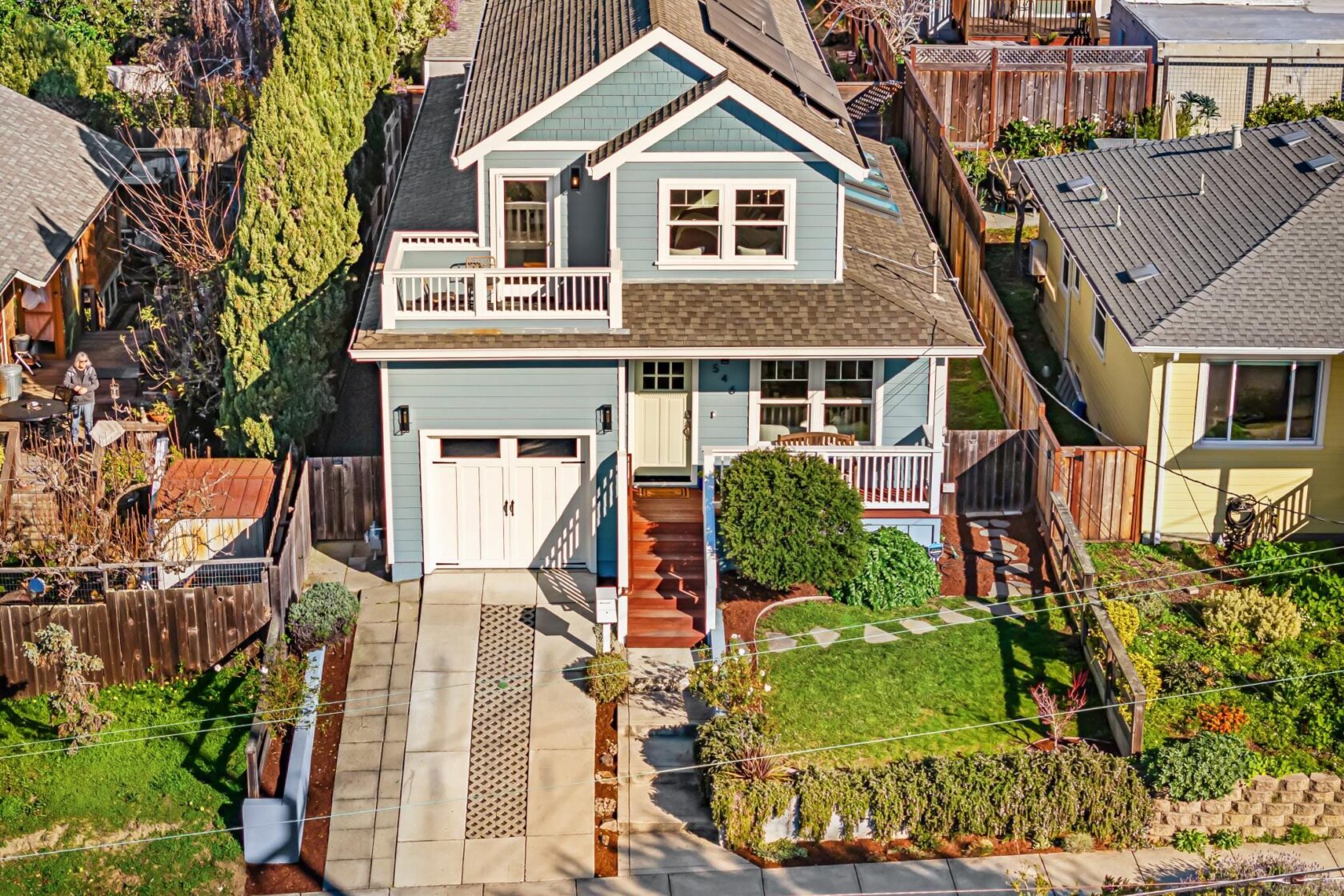 Aerial photograph of 546 Norvell Street showing a two-story craftsman-style home with a small front yard, garage, and neighboring residential properties on a standard lot.