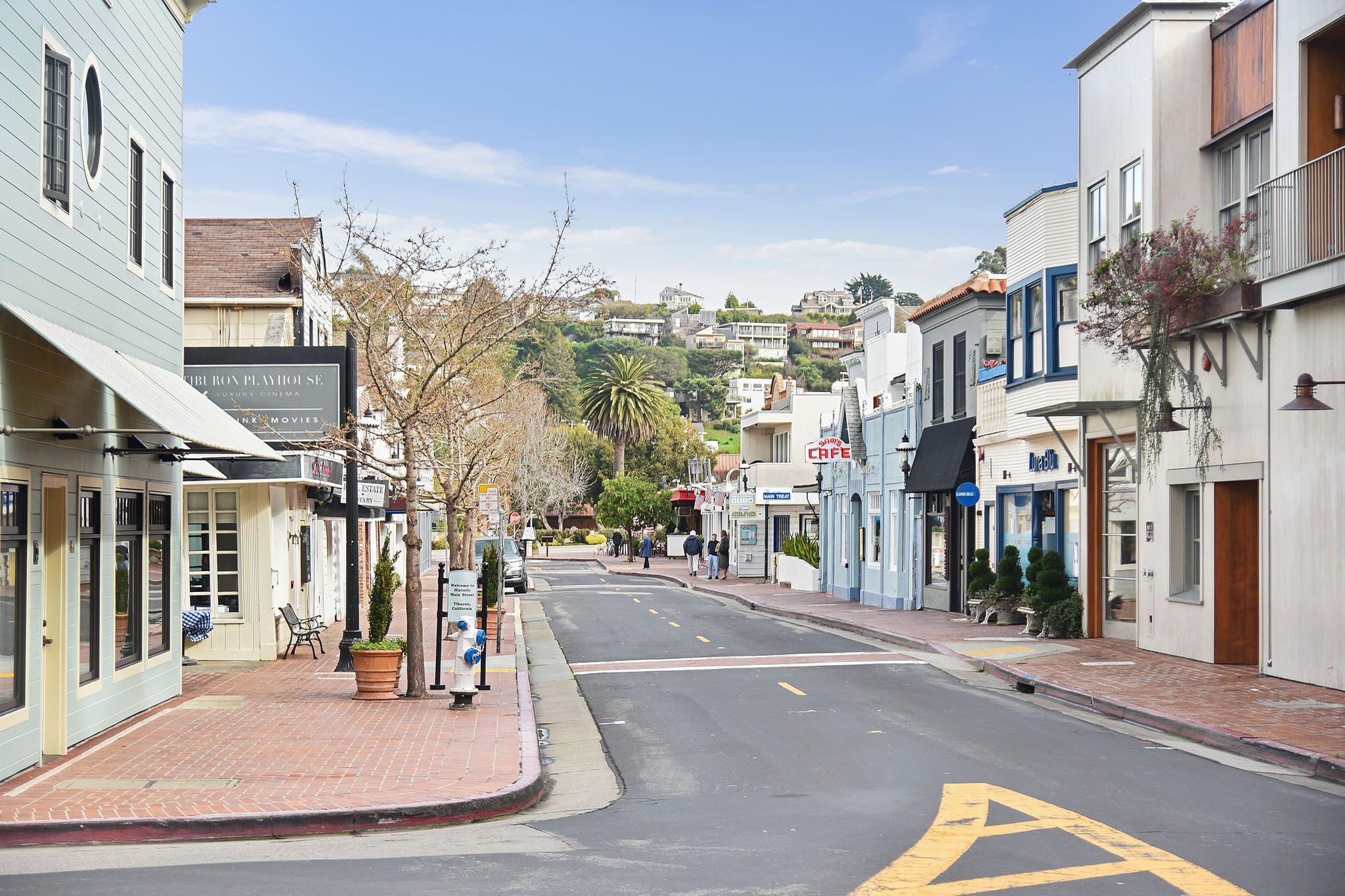 Main Street Tiburon looking uphill with local shops, Tiburon Playhouse, and hillside homes in the background